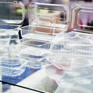 Plastic disposable food containers in showcase of shop