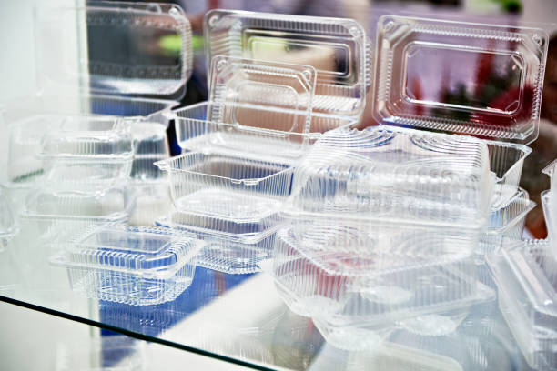 Plastic disposable food containers in showcase of shop